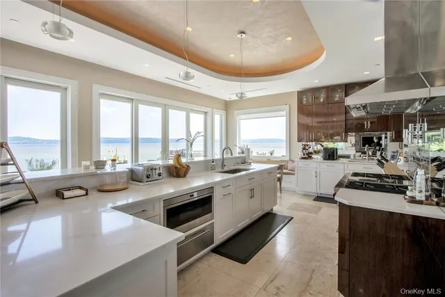 a kitchen with sink stove and cabinets