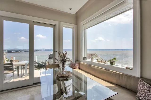 a very nice looking room with a large window and furniture