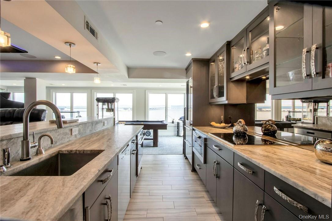 74 River Road Nyack, NY 10960 - Photo 17 of 36 a kitchen with stainless steel appliances granite countertop a sink stove and cabinets