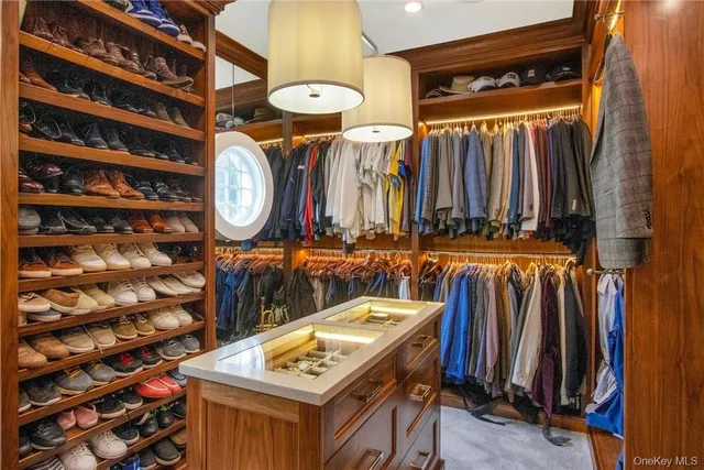 a view of walk in closet with clothes and shoes