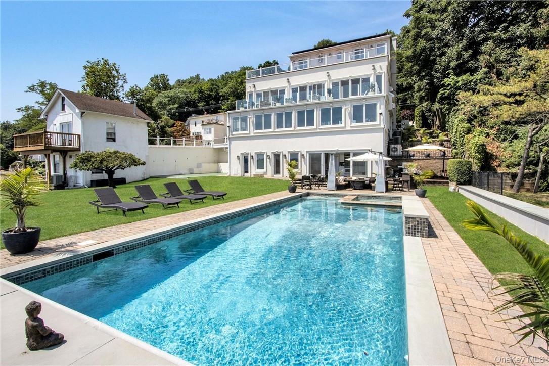 74 River Road Nyack, NY 10960 - Photo 3 of 36 a view of a house with swimming pool and a yard