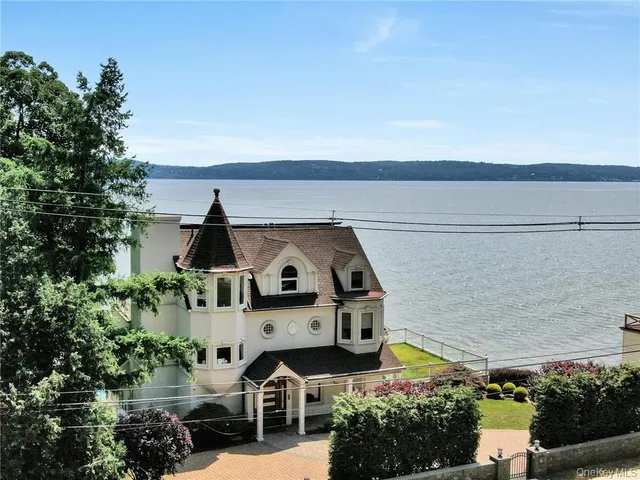 an aerial view of a house with a yard