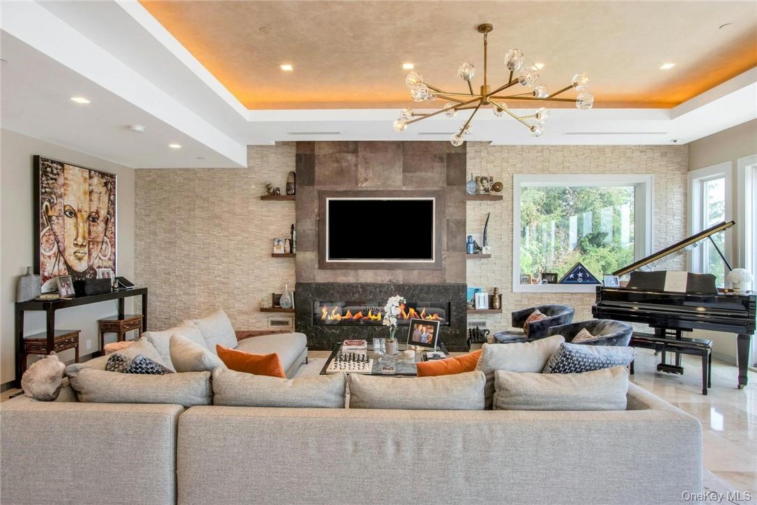 74 River Road Nyack, NY 10960 - Photo 7 of 36 a living room with furniture a large window and a flat screen tv