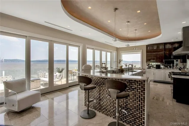 a very nice looking living room with a large dining table and a large window