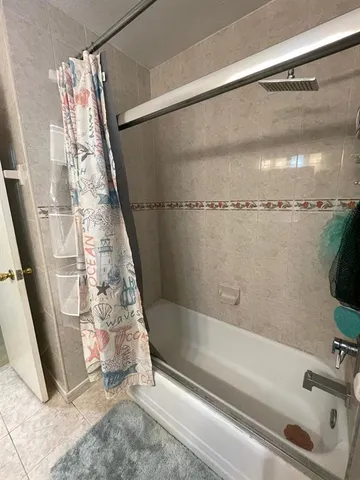 a bathroom with a shower and a tub