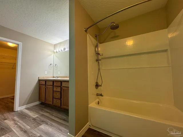 a bathroom with a tub a sink and a shower