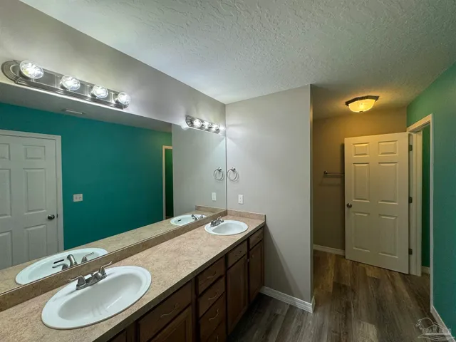 a bathroom with a sink double vanity and a mirror