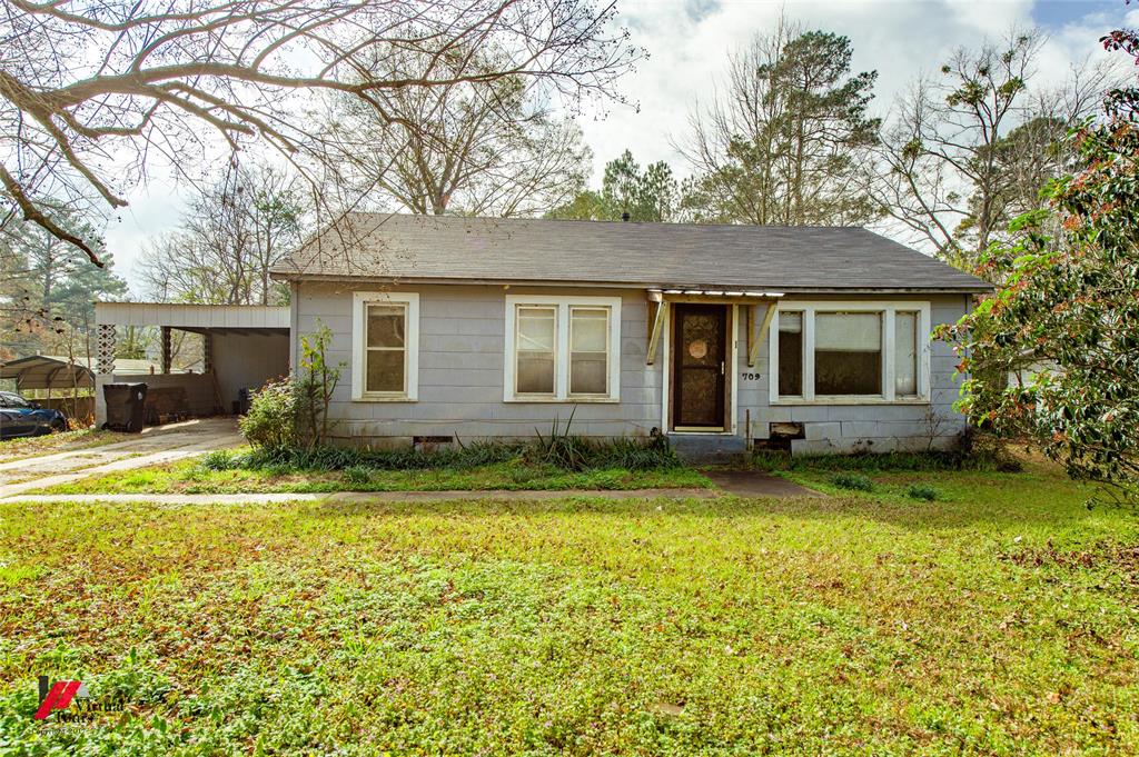Bungalow-style house featuring a front yard and an attached carport