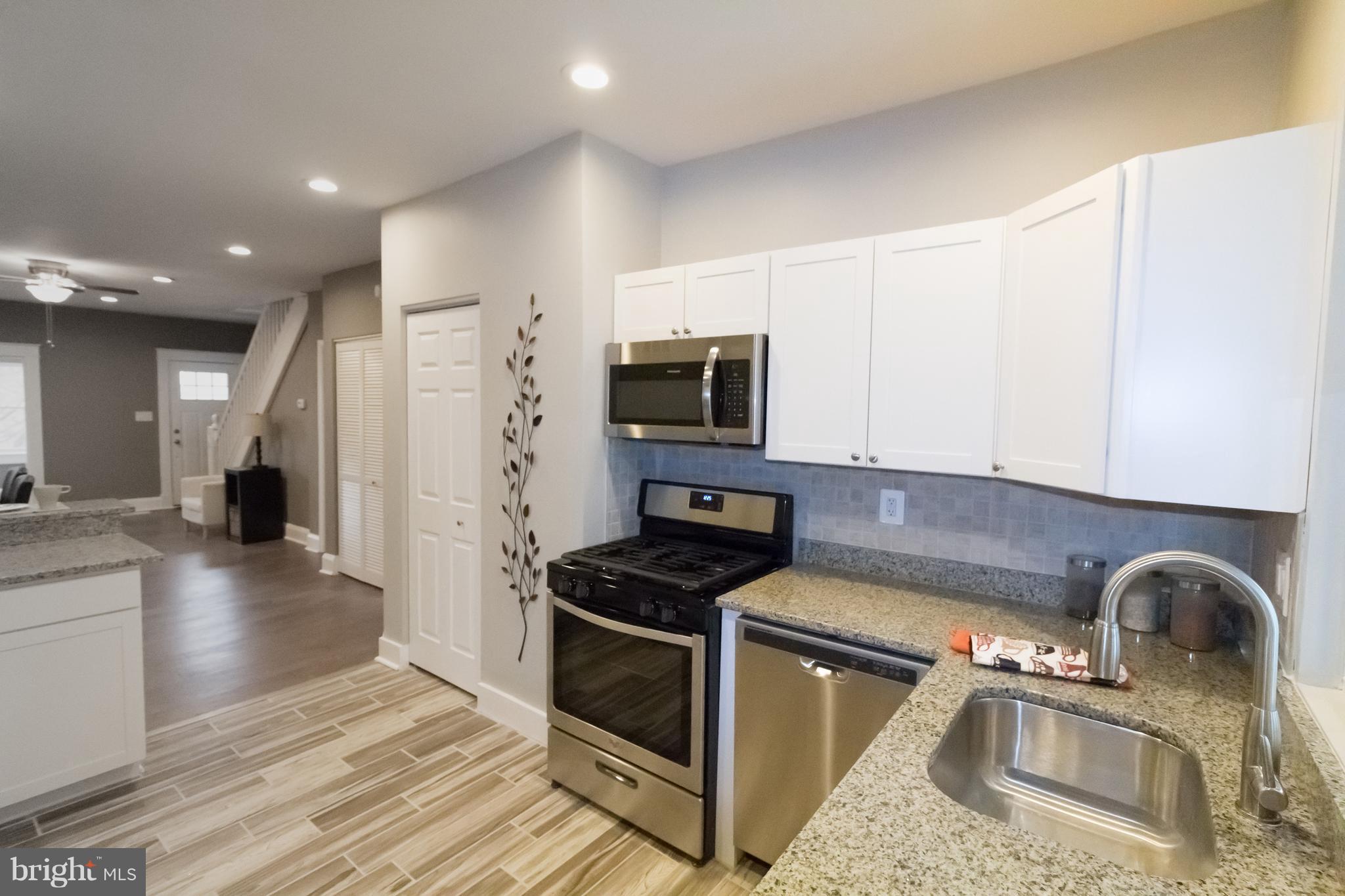 1743 Portship Road Baltimore, MD 21222 - Photo 12 of 30 a kitchen with granite countertop a stove and a sink