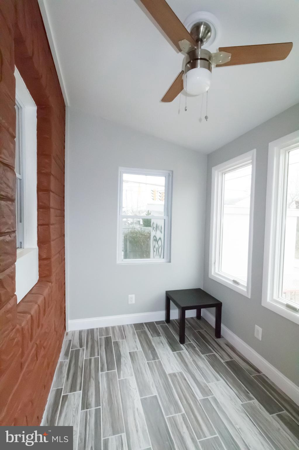 1743 Portship Road Baltimore, MD 21222 - Photo 19 of 30 a view of wooden floor and windows in a room