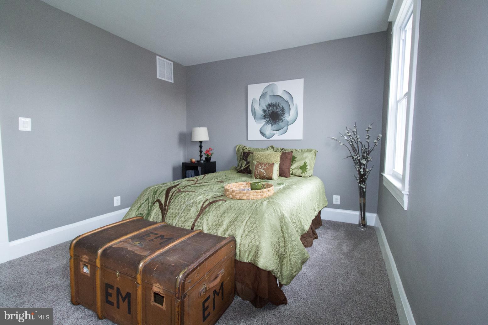 1743 Portship Road Baltimore, MD 21222 - Photo 20 of 30 a bedroom with a bed and painting on the wall