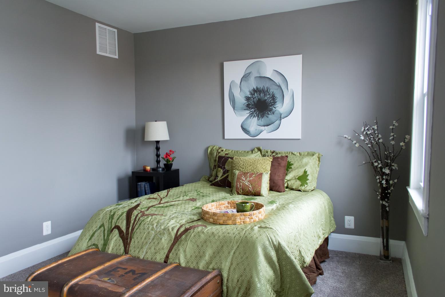 1743 Portship Road Baltimore, MD 21222 - Photo 21 of 30 a bed sitting in a bedroom and a lamp