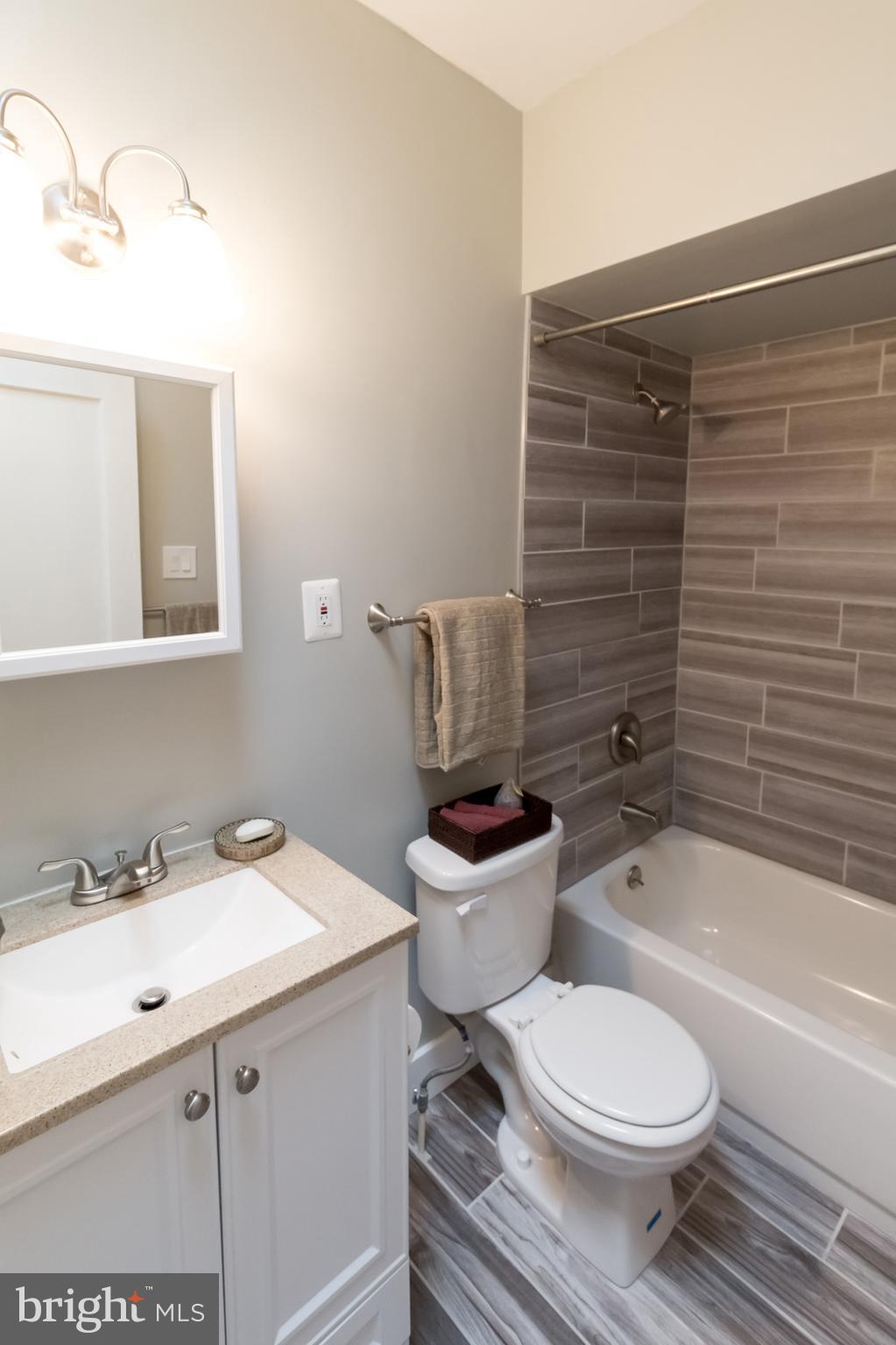 1743 Portship Road Baltimore, MD 21222 - Photo 22 of 30 a bathroom with a sink a toilet and bathtub