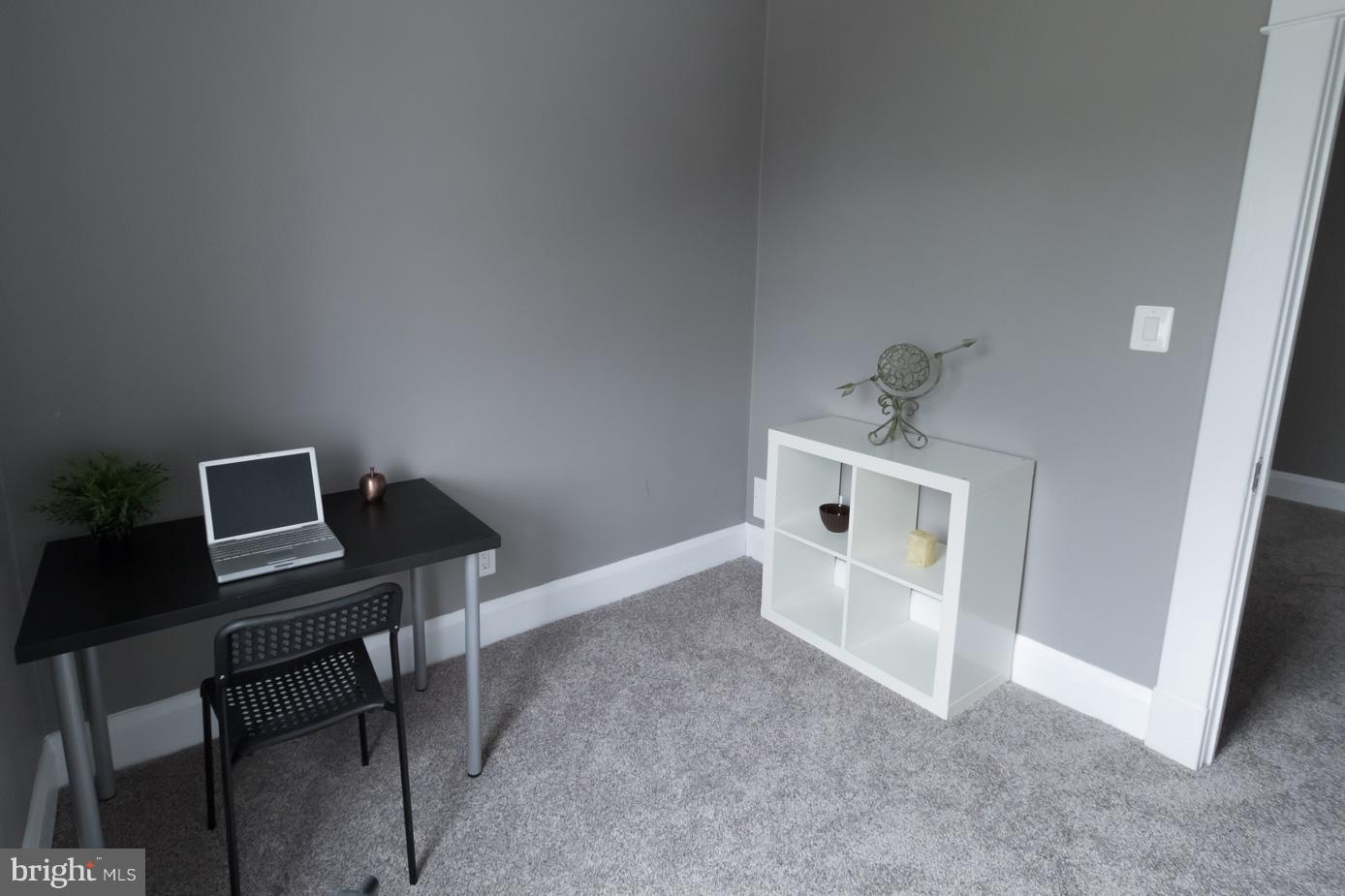 1743 Portship Road Baltimore, MD 21222 - Photo 26 of 30 a view of a workspace with furniture and wooden floor