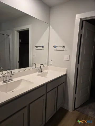 a bathroom with a sink double vanity and a mirror