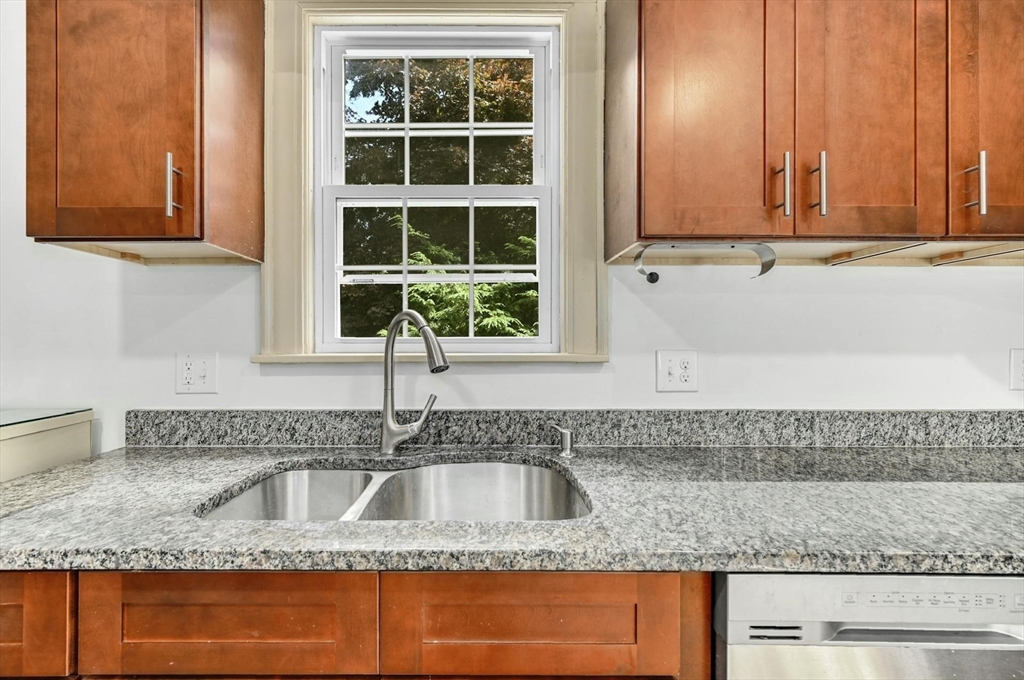 41 Flagg Street Worcester, MA 01602 - Photo 11 of 31 a kitchen with granite countertop a sink and a stove