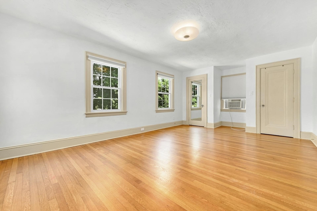 41 Flagg Street Worcester, MA 01602 - Photo 18 of 31 an empty room with wooden floor and windows