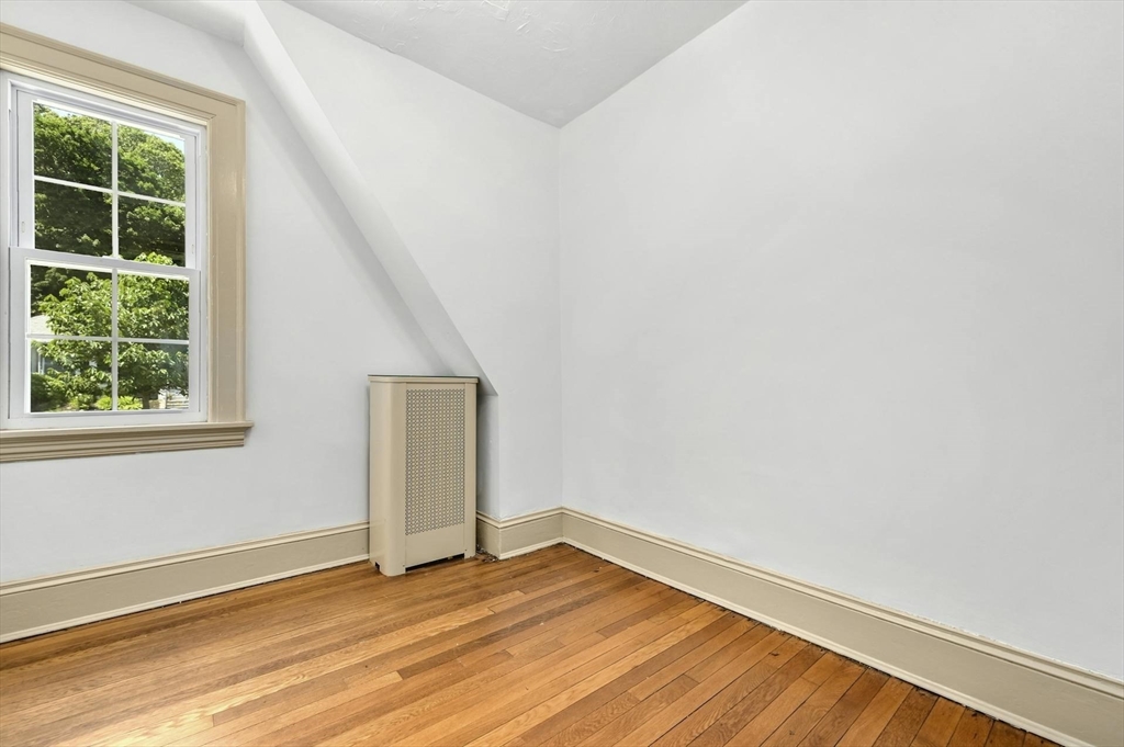 41 Flagg Street Worcester, MA 01602 - Photo 25 of 31 a view of an empty room with wooden floor and a window