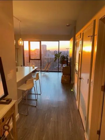 a view of a room with furniture and wooden floor