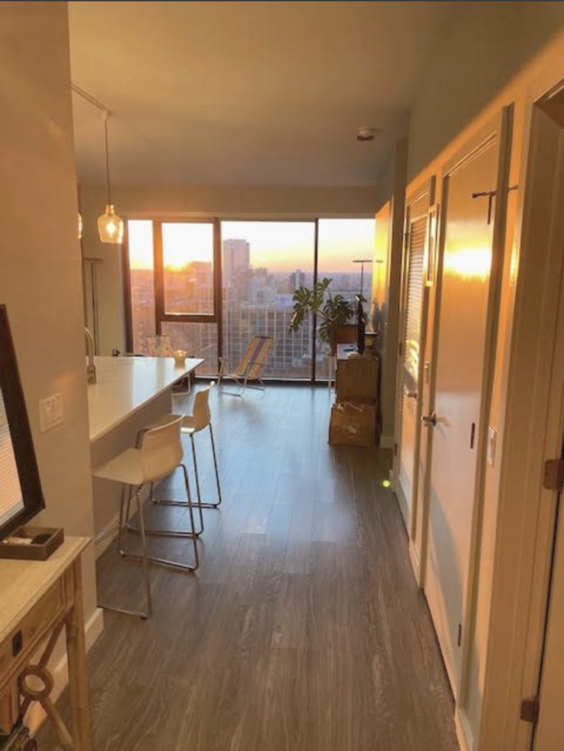 833 North Clark Street, Unit 2408 Chicago, IL 60610 - Photo 11 of 21 a view of a room with furniture and wooden floor