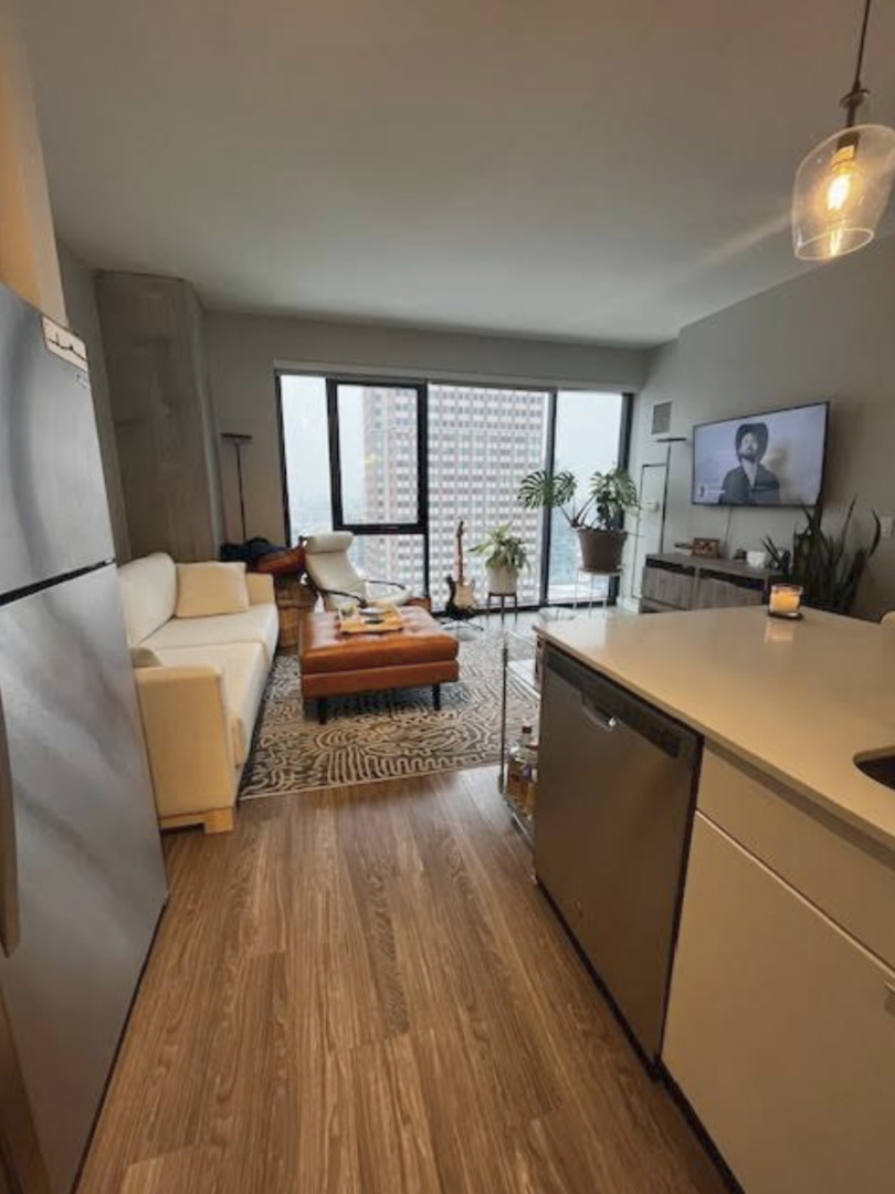 833 North Clark Street, Unit 2408 Chicago, IL 60610 - Photo 6 of 21 a bed room with a bed and a large window