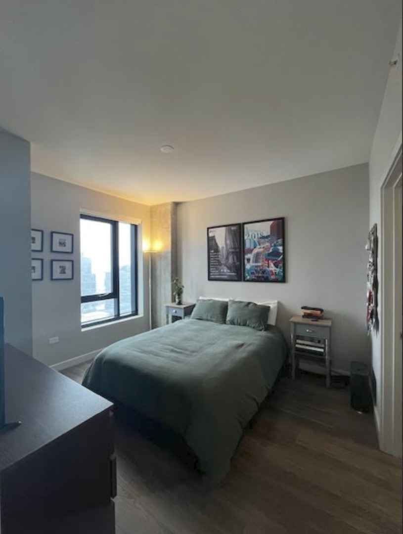 833 North Clark Street, Unit 2408 Chicago, IL 60610 - Photo 10 of 21 a bedroom with a bed and a table in it with window