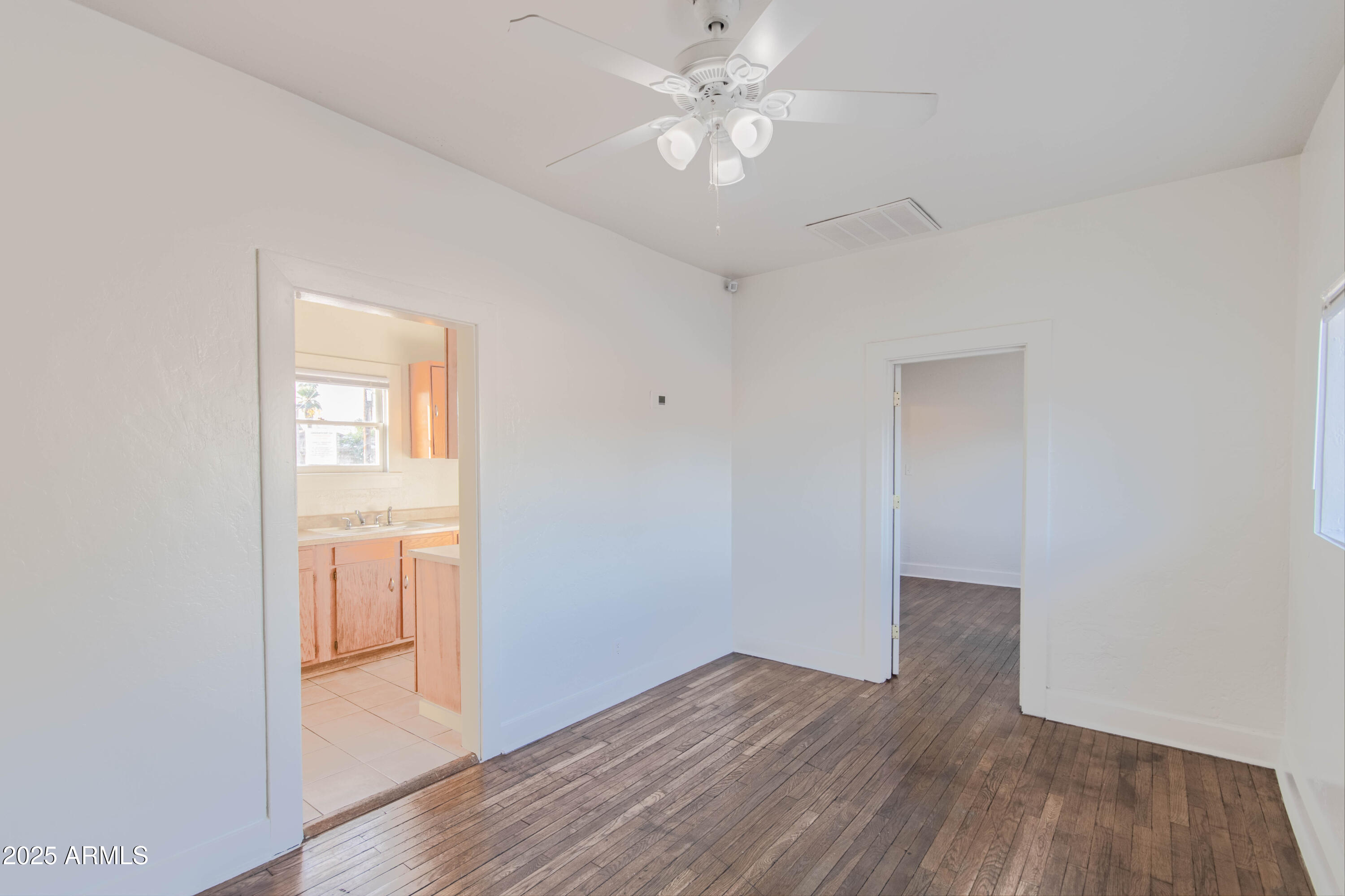 2032 West Adams Street, Unit 3 Phoenix, AZ 85009 - Photo 2 of 10 an empty room with wooden floor and windows