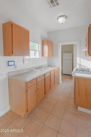 a spacious bathroom with a granite countertop sink and a mirror