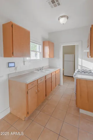a spacious bathroom with a granite countertop sink and a mirror