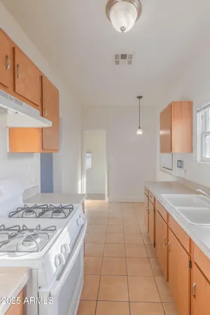a kitchen with a sink stove and cabinets