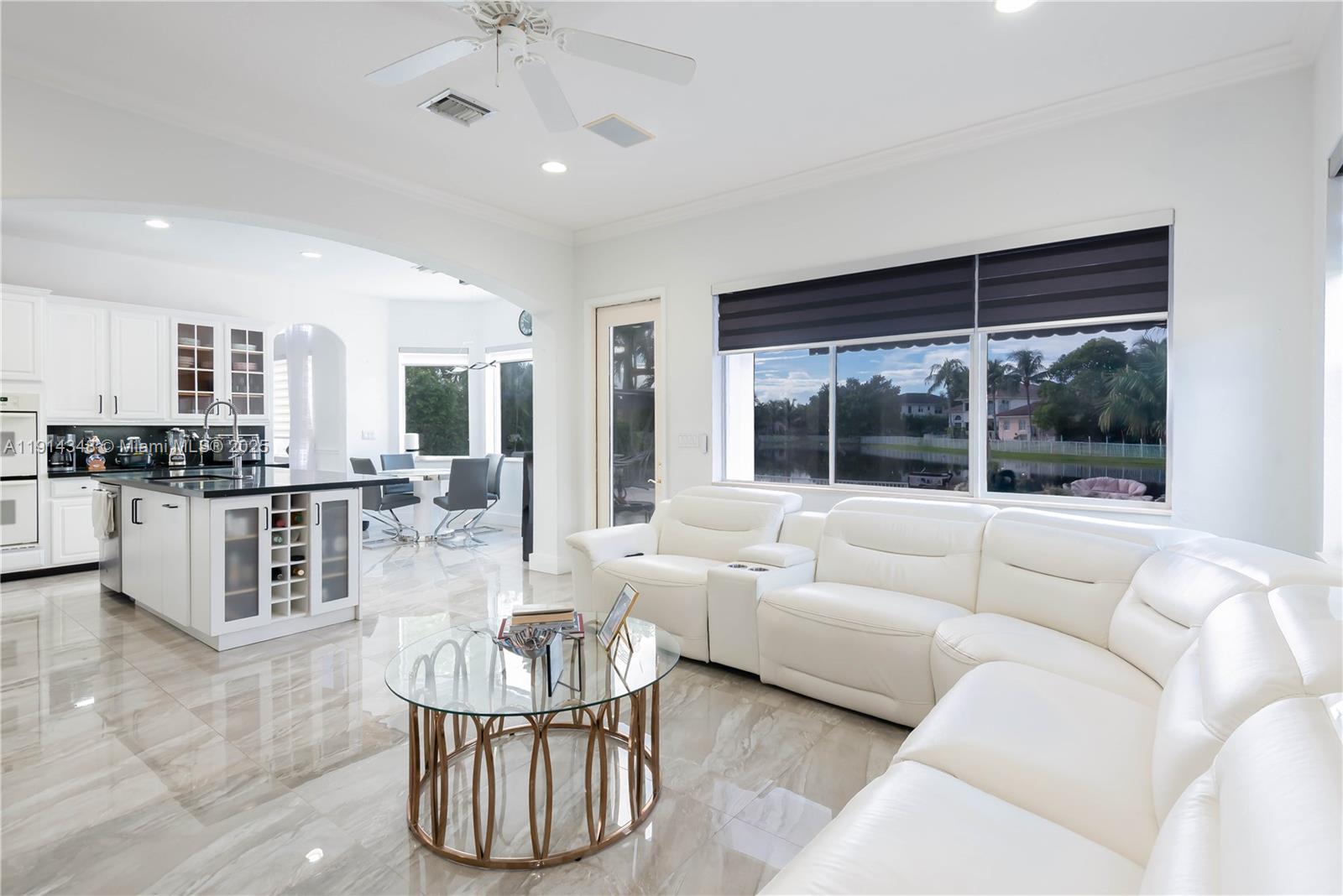 19250 Southwest 30th Street, Unit 50 Miramar, FL 33029 - Photo 26 of 61 a living room with furniture and a large window with kitchen view