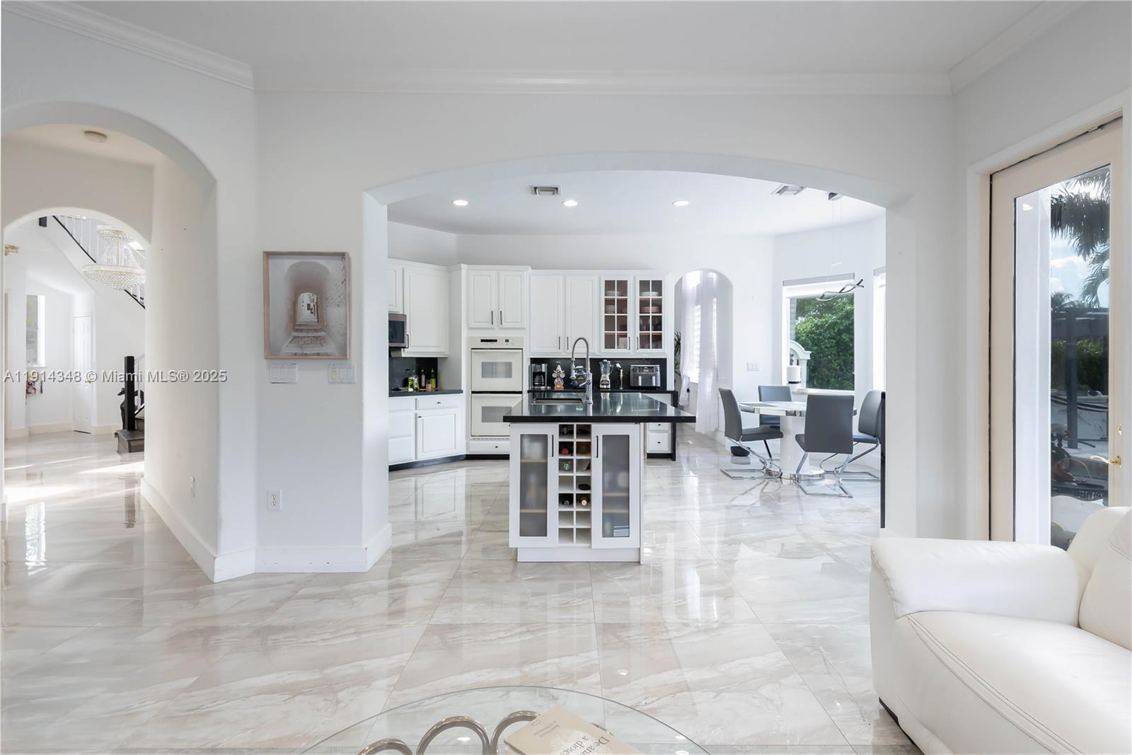 19250 Southwest 30th Street, Unit 50 Miramar, FL 33029 - Photo 27 of 61 a living room filled with stainless steel appliances kitchen island granite countertop furniture and a view of kitchen