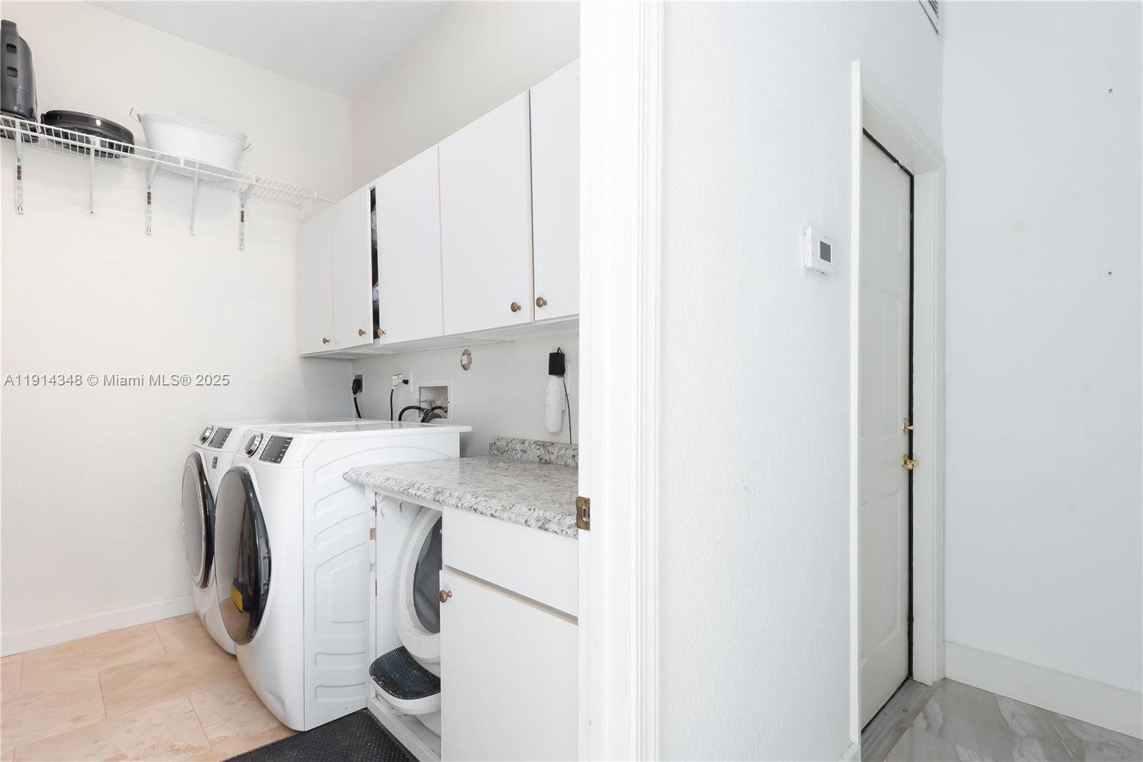 19250 Southwest 30th Street, Unit 50 Miramar, FL 33029 - Photo 35 of 61 a utility room with cabinets washer and dryer