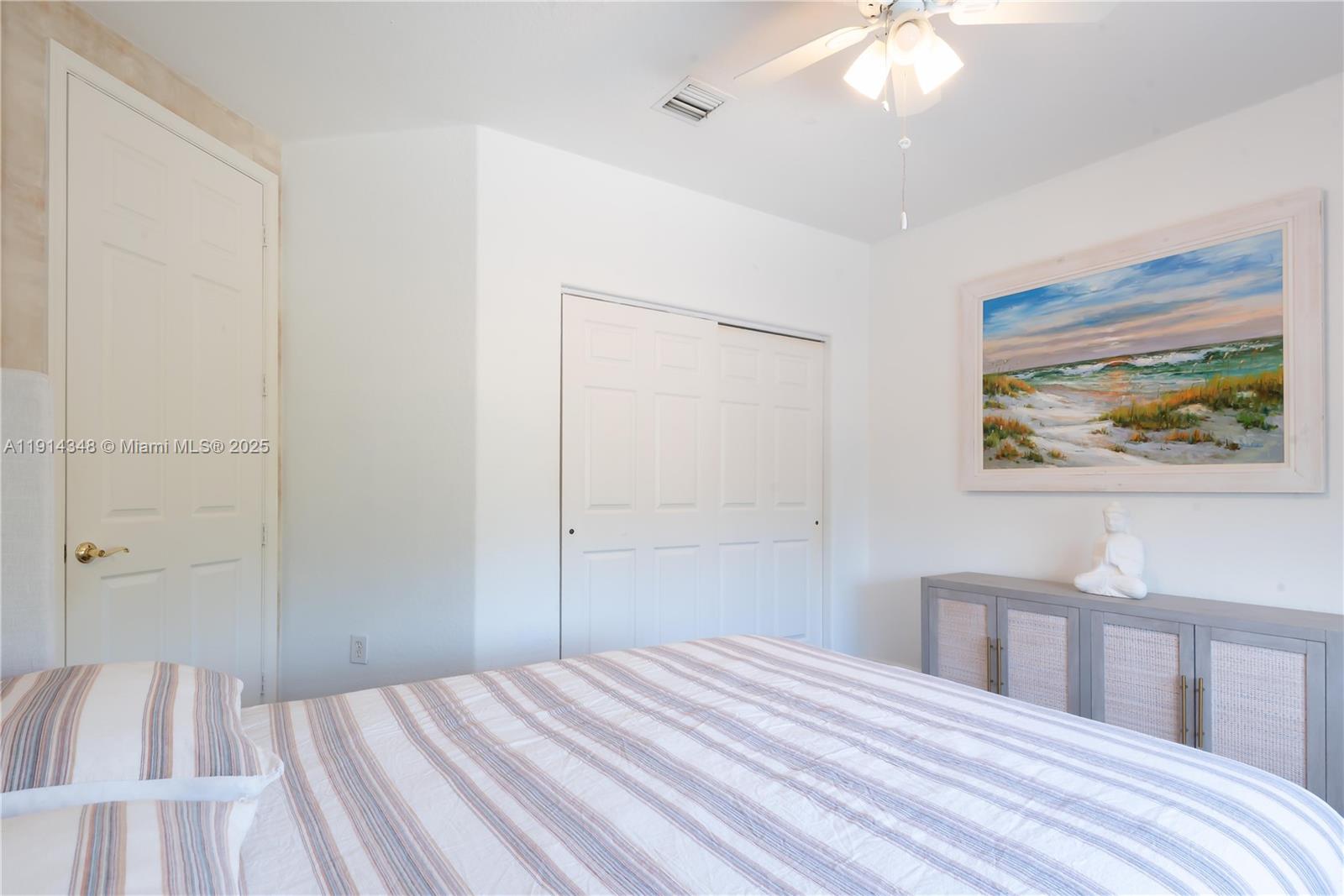 19250 Southwest 30th Street, Unit 50 Miramar, FL 33029 - Photo 47 of 61 a bedroom with a bed and a chandelier