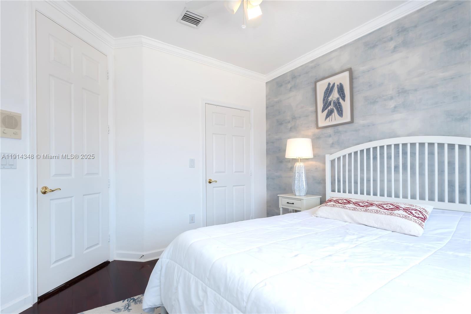 19250 Southwest 30th Street, Unit 50 Miramar, FL 33029 - Photo 49 of 61 a bedroom with a bed and a chandelier