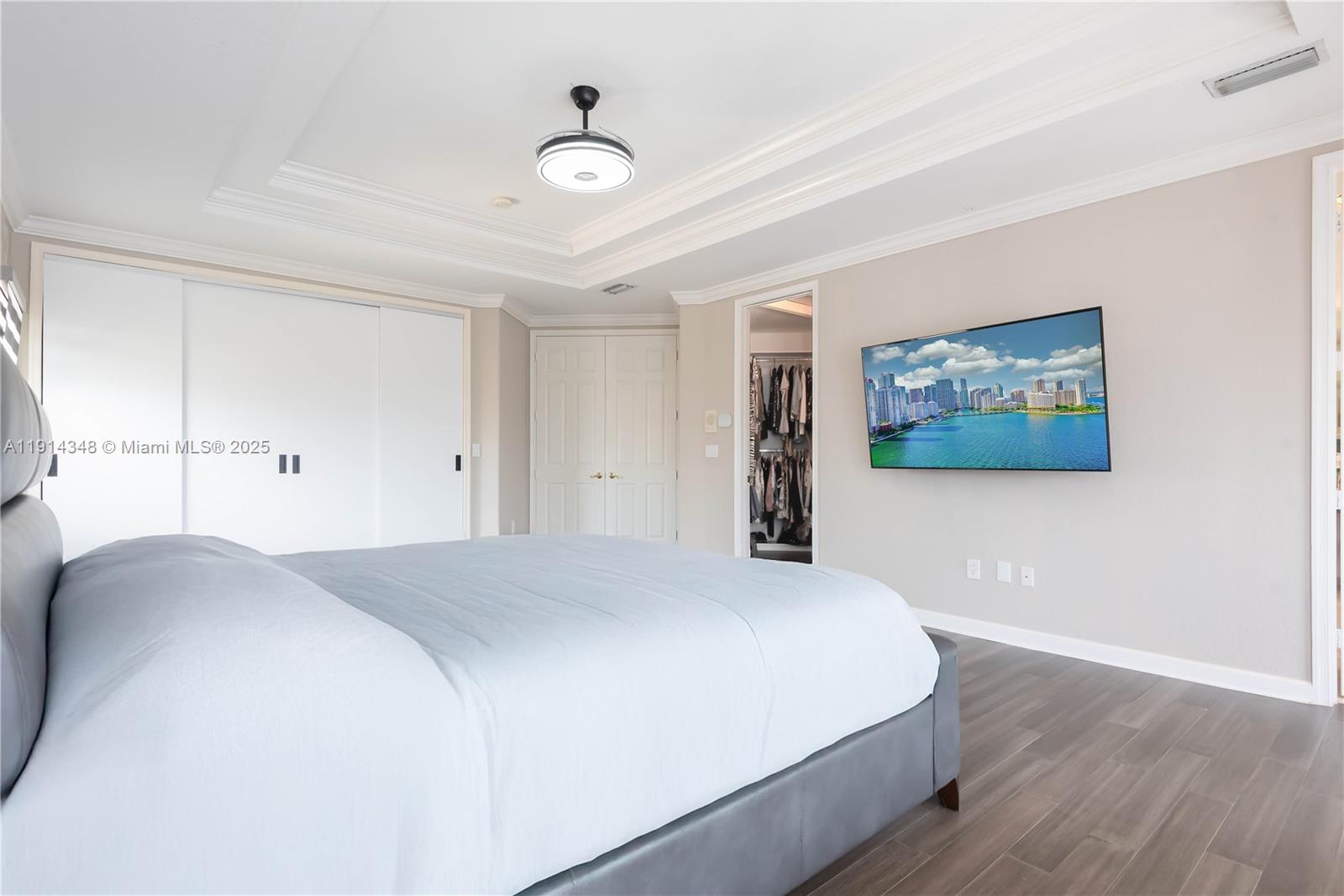 19250 Southwest 30th Street, Unit 50 Miramar, FL 33029 - Photo 55 of 61 a bedroom with a large bed and a chandelier