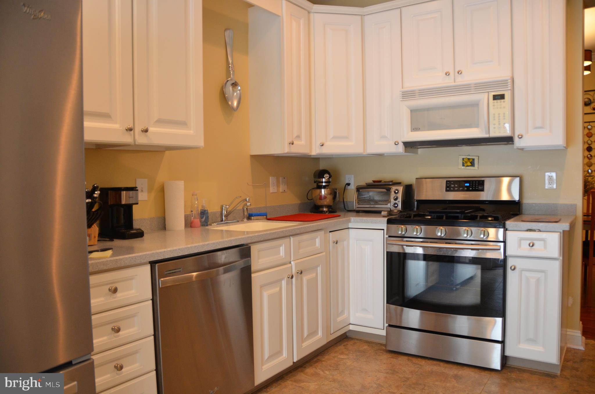 113 Warwick Road Princeton Junction, NJ 08550 - Photo 12 of 31 a kitchen with stainless steel appliances granite countertop a sink a stove and cabinets