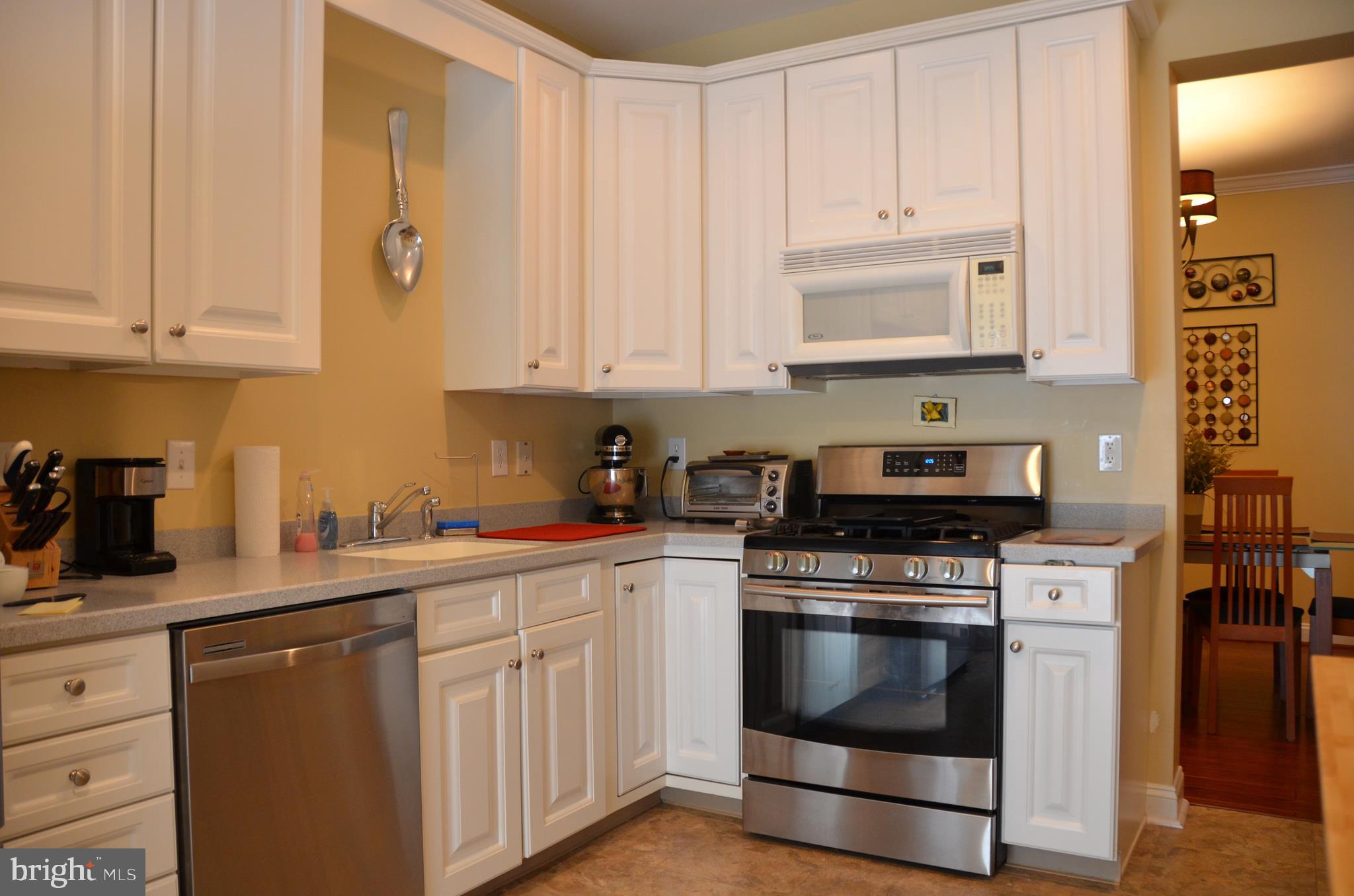 113 Warwick Road Princeton Junction, NJ 08550 - Photo 13 of 31 a kitchen with white cabinets and white appliances