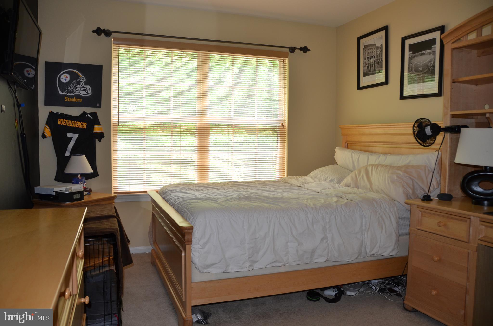 113 Warwick Road Princeton Junction, NJ 08550 - Photo 20 of 31 a bedroom with a bed and a flat tv screen on the dresser