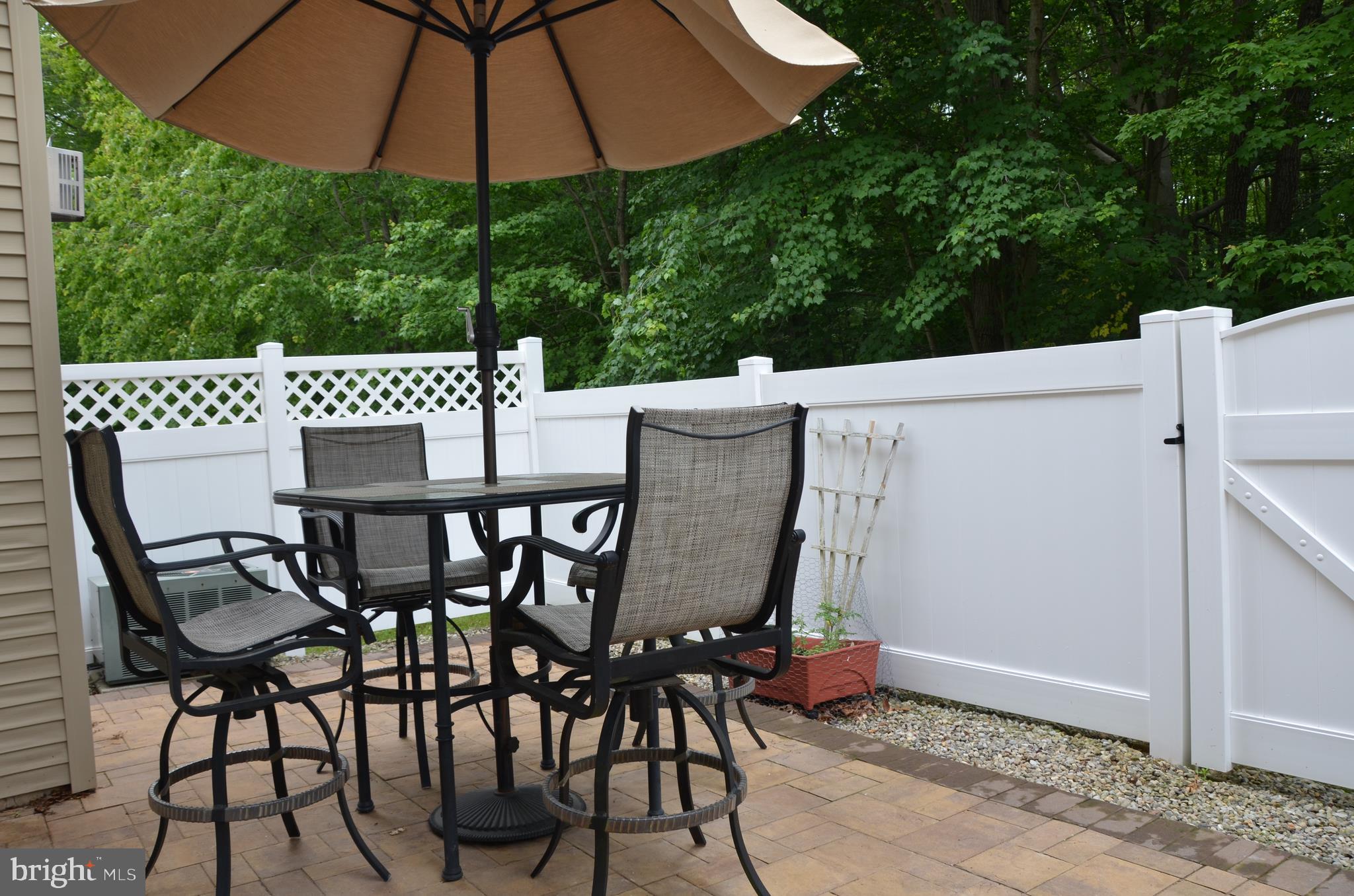 113 Warwick Road Princeton Junction, NJ 08550 - Photo 26 of 31 a patio with wooden floor a yard table and chairs