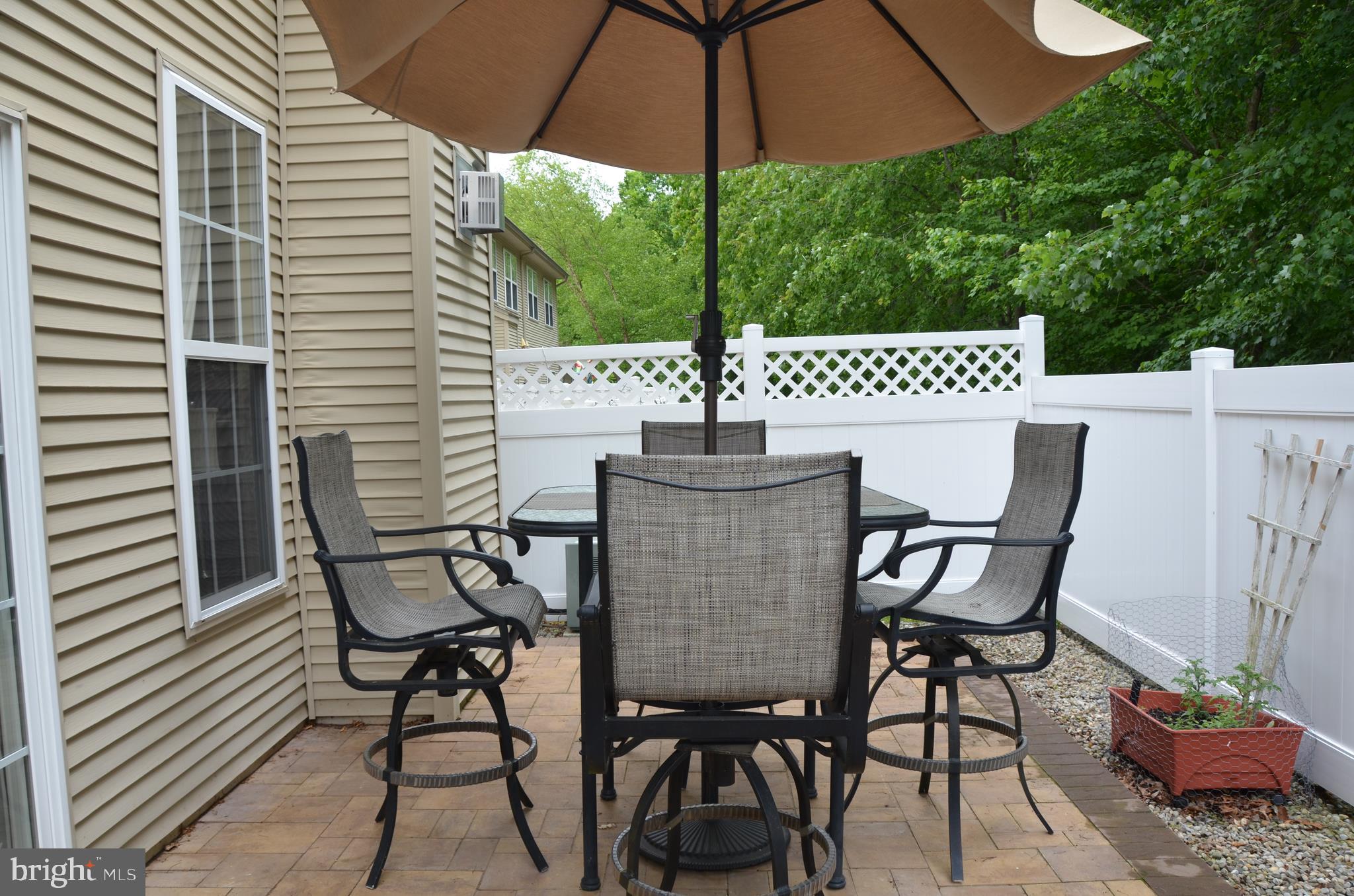113 Warwick Road Princeton Junction, NJ 08550 - Photo 27 of 31 a view of a patio with table and chairs under an umbrella