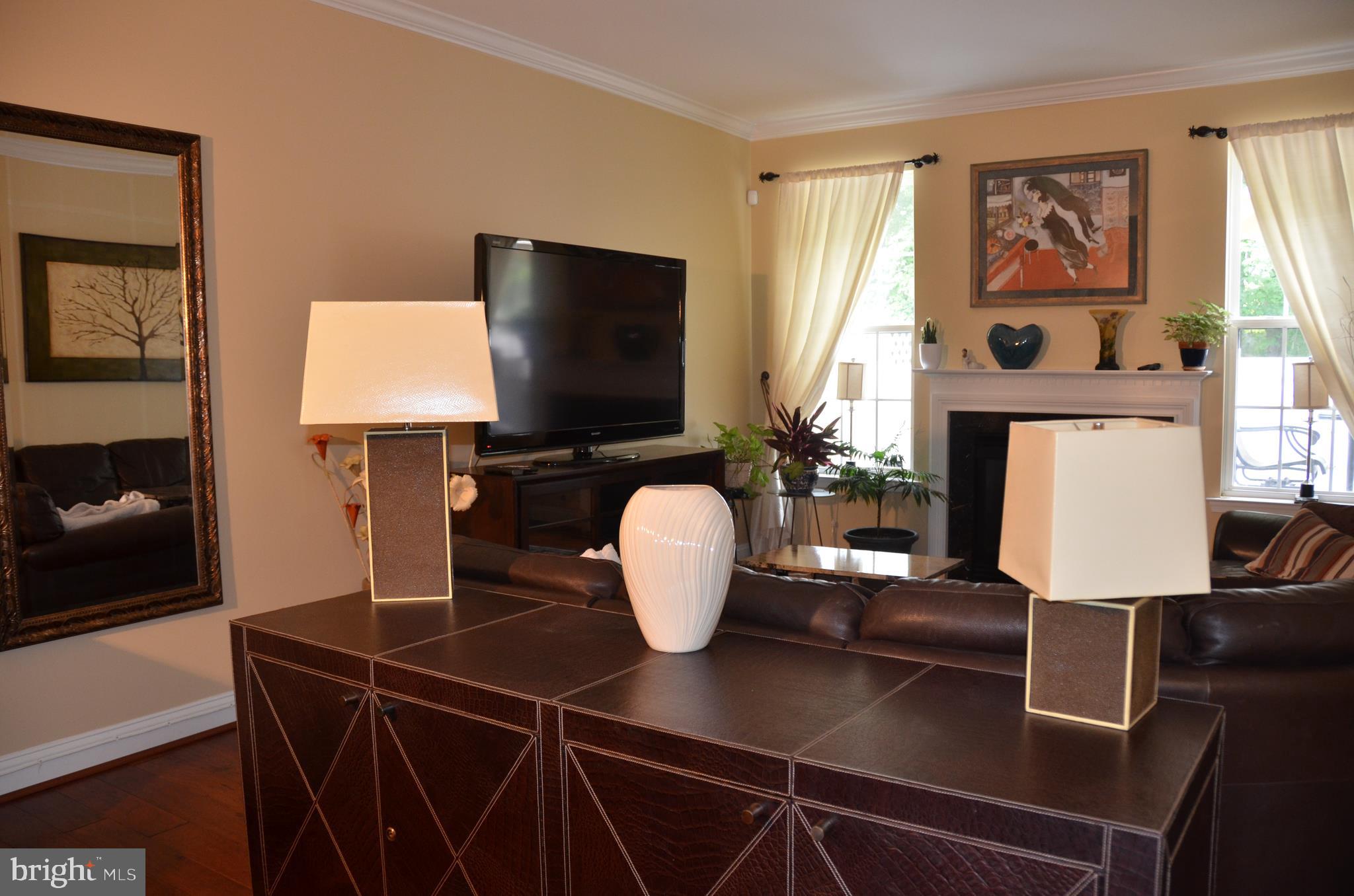 113 Warwick Road Princeton Junction, NJ 08550 - Photo 9 of 31 a living room with furniture and a flat screen tv