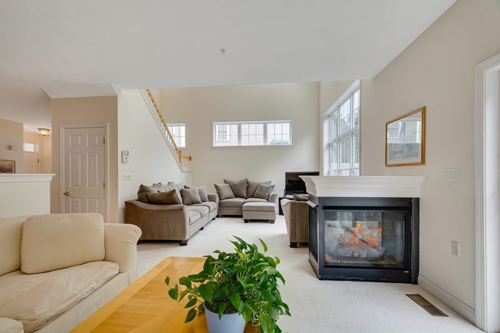 508 Linwood Court, Unit 508 Clinton, MA 01510 - Photo 14 of 28 a living room with furniture a fireplace and a window