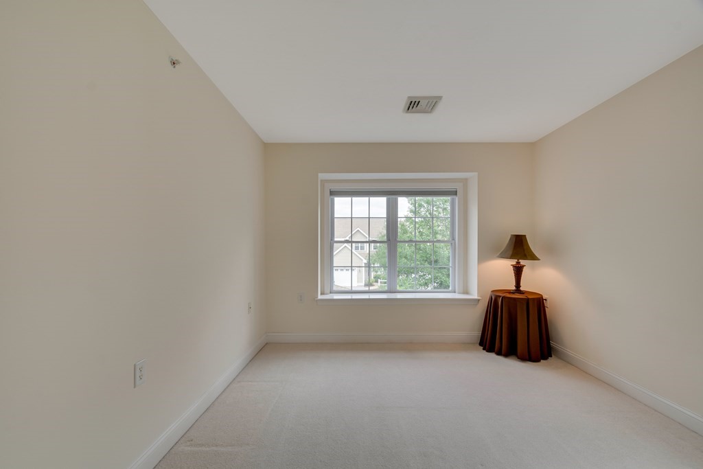 508 Linwood Court, Unit 508 Clinton, MA 01510 - Photo 20 of 28 a room with a window and a chandelier fan