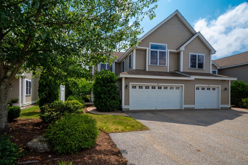 508 Linwood Court, Unit 508 Clinton, MA 01510 - Photo 2 of 28 a front view of a house with a garden and yard