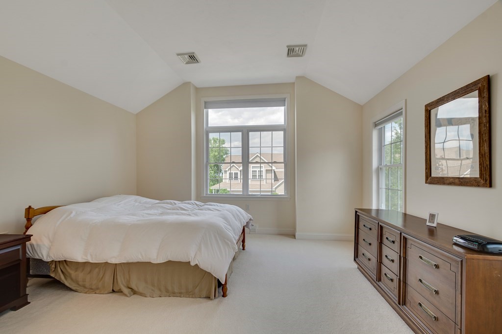 508 Linwood Court, Unit 508 Clinton, MA 01510 - Photo 21 of 28 a bedroom with a bed and wooden floor