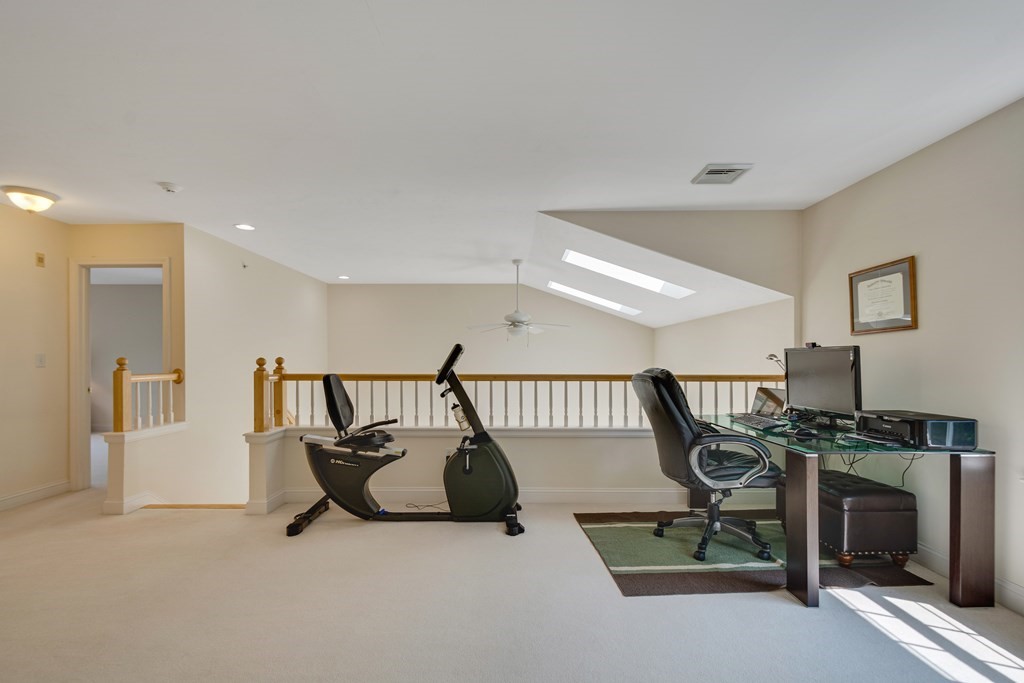508 Linwood Court, Unit 508 Clinton, MA 01510 - Photo 27 of 28 a living room with furniture a flat screen tv and a table