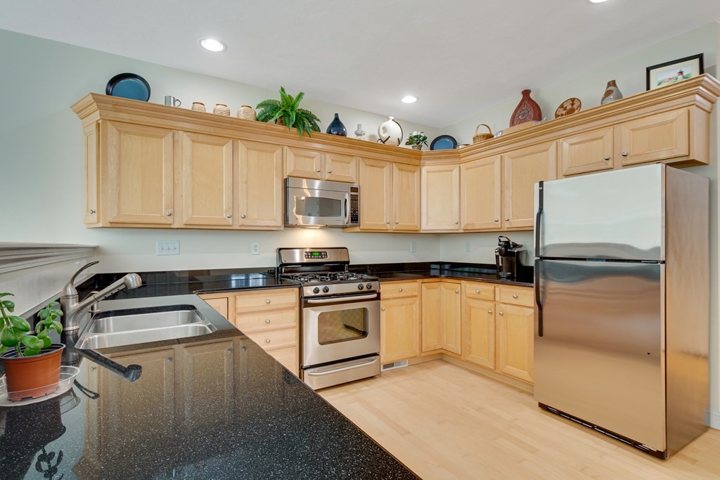 508 Linwood Court, Unit 508 Clinton, MA 01510 - Photo 9 of 28 a kitchen with stainless steel appliances granite countertop a refrigerator sink and stove