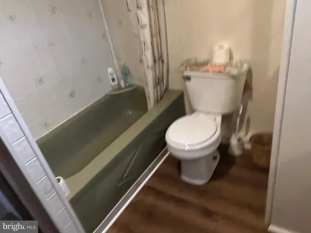 a white toilet sitting next to a sink