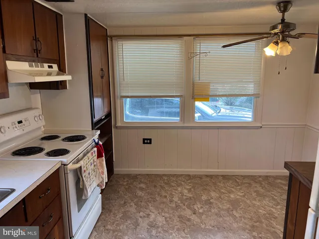 a kitchen with a stove and a wooden cabinets